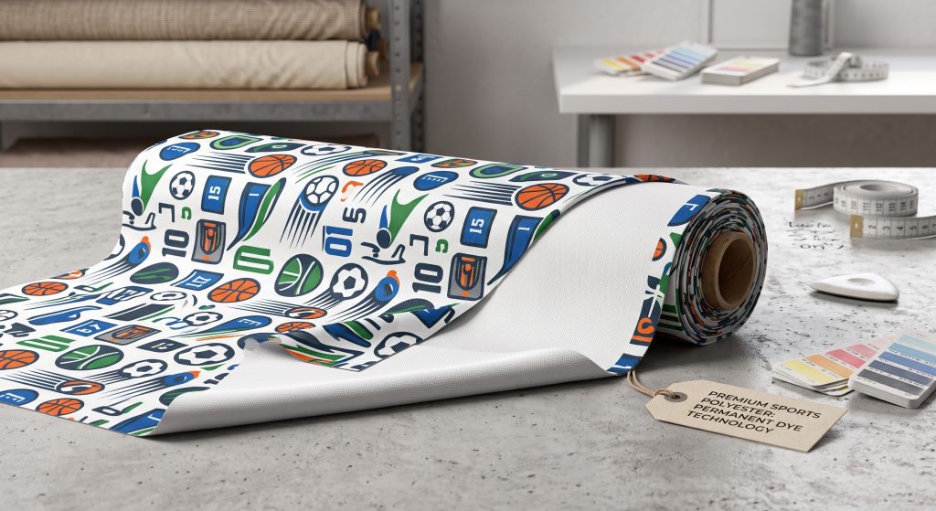 A realistic close-up photo of a partially unrolled premium polyester sports fabric roll featuring a detailed pattern of multi-colored sports icons and a printed hangtag in a textile design studio.