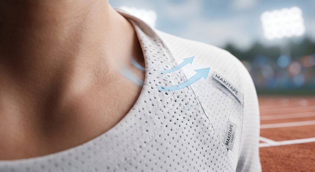 A high-resolution technical macro photograph visualizing Birdseye sports ball fabric's specialized flat, non-abrasive double-knit interior structure in contact with athletic bare skin. Faint dynamic visualization arrows show cool air flowing through the geometric eyelet micro-mesh pattern, illustrating how the fabric minimizes contact and manages moisture to eliminate chafing during extreme summer sports, allowing maximum athlete focus.