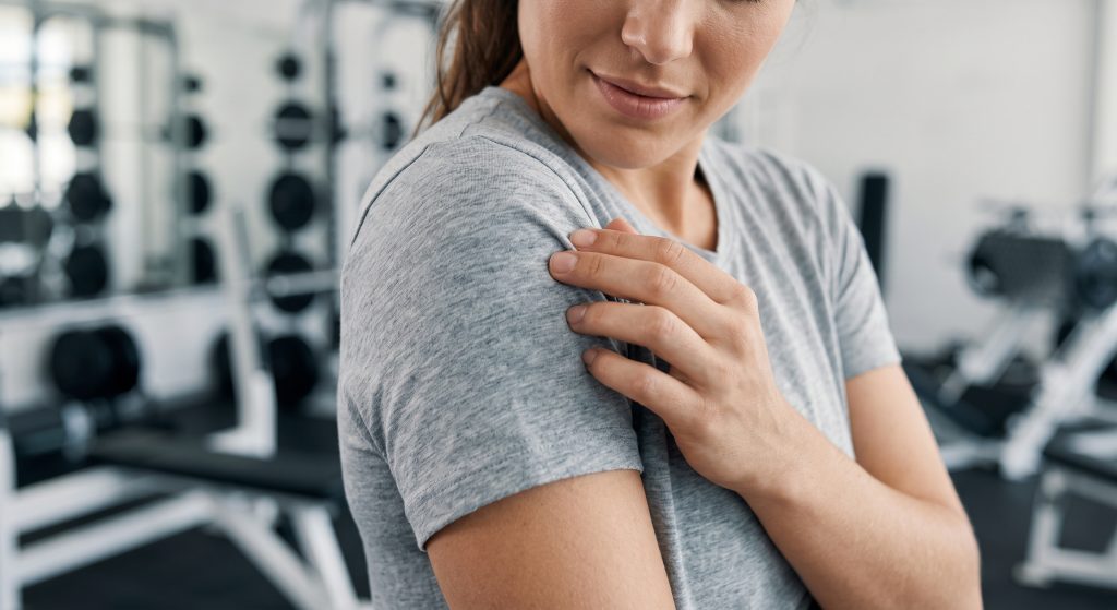 Close-up of a female athlete gently feeling a soft flat-knit sports team cotton blend shirt, emphasizing its skin-friendly natural touch.