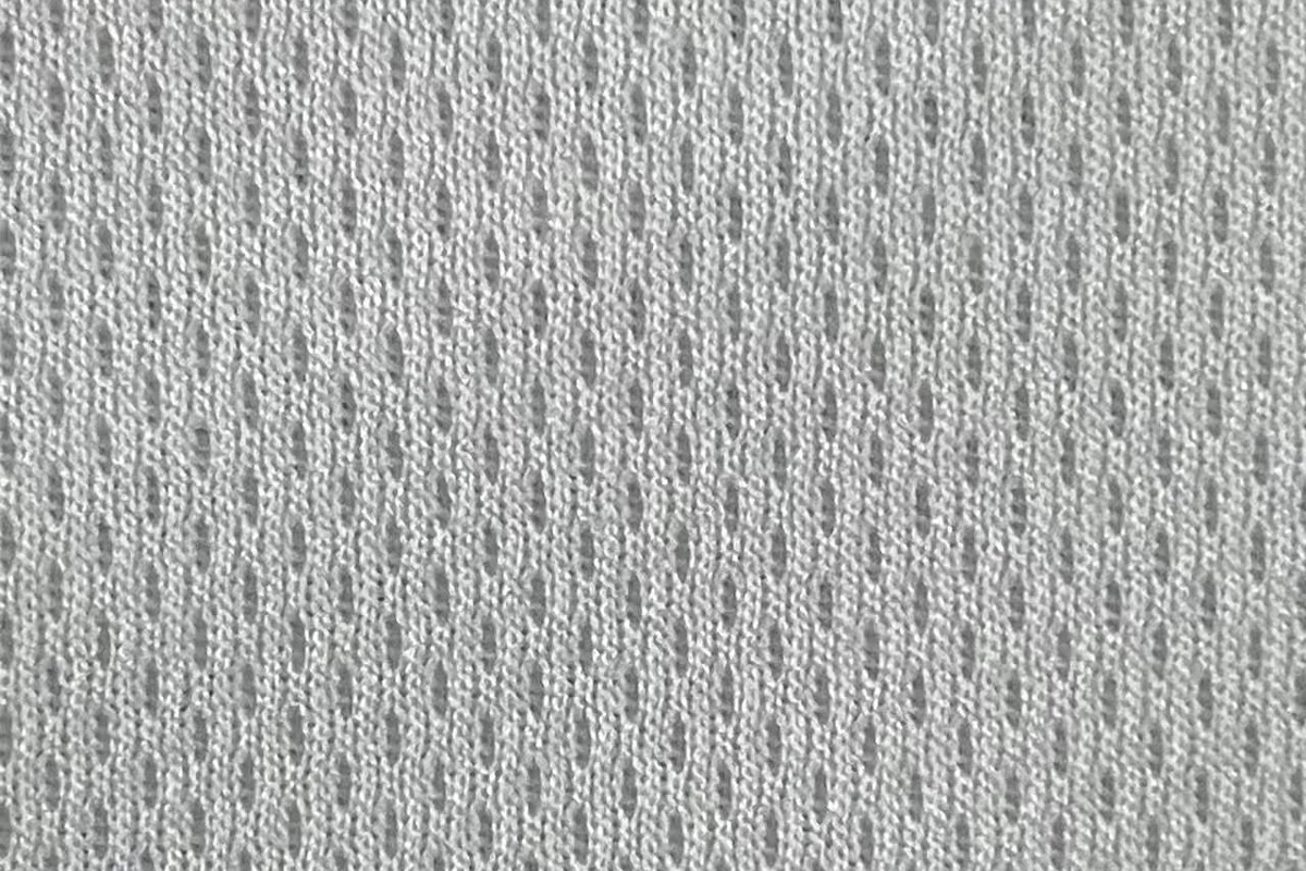 Close-up texture detail of white 100% polyester 75D fine birdseye pin dot mesh fabric, SY013