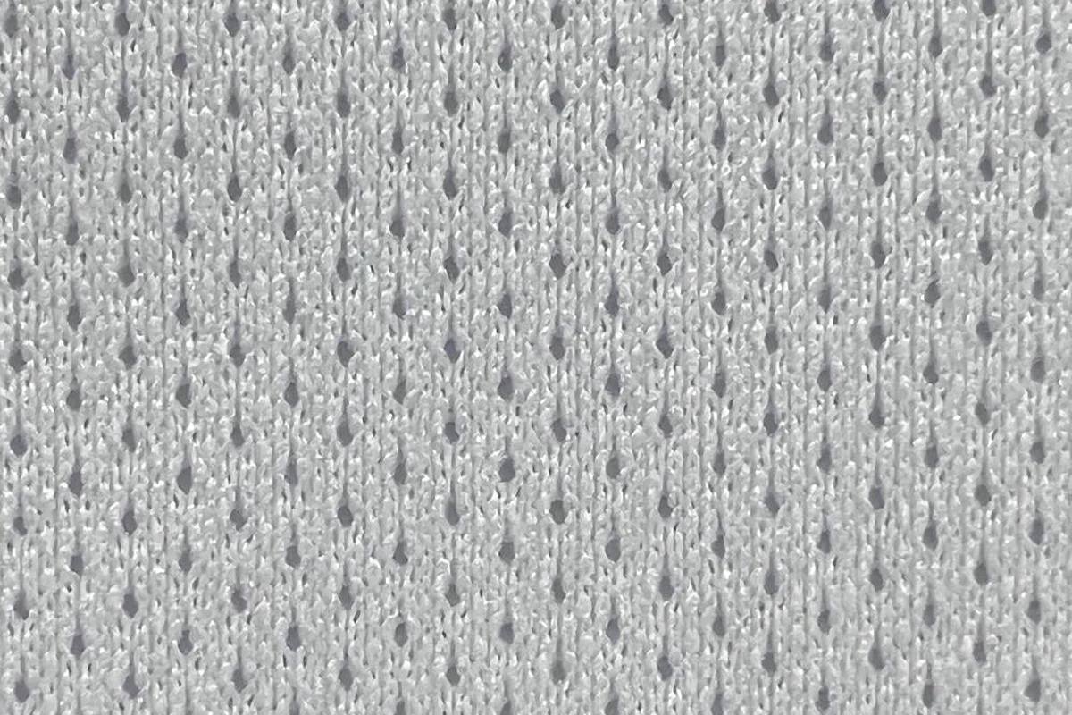 Close-up texture detail of white 100% DTY polyester lightweight birdseye pin dot mesh fabric, SY185