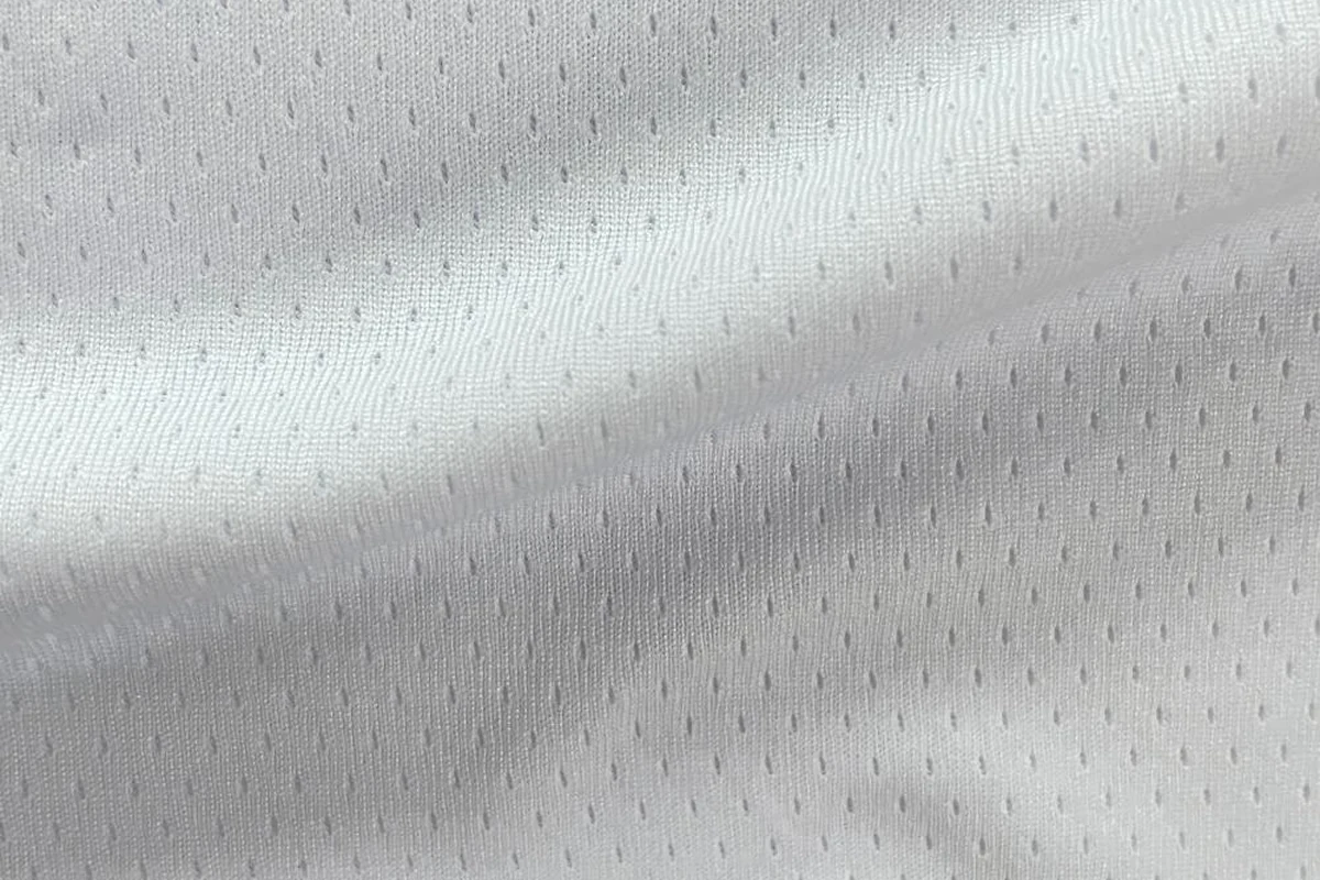 Draped white 100% polyester medium-heavy 24-gauge dotted mesh fabric, structured pin dot texture, item SY9009, 180-190gsm